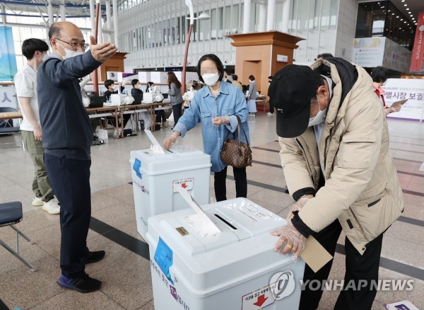 4·7 재·보궐선거 사전투표 첫날인 2일 서울역에 설치된 남영동 사전투표소에서 시민들이 투표함에 투표용지를 넣고 있다. 사전투표는 2~3일 이틀 동안 오전 6시부터 오후 6시까지 진행된다. [사진=연합뉴스]