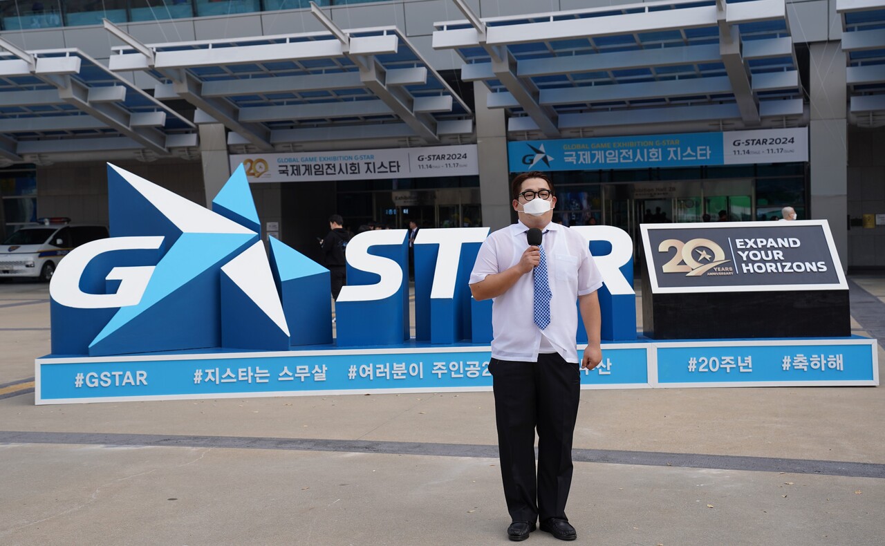 튜브 채널 '빠더너스 BDNS'의 '한국지리 일타강사 문쌤' 캐릭터를 통해 대중들에게 많은 사랑을 받은 문상훈 배우가 지스타 모형 앞에서 촬영하고 있다. [사진=김민우 기자]