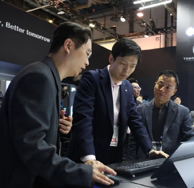 신유열 롯데지주 미래성장실장(가운데)이 지난해 1월 미국 라스베이거스에서 열린 ‘CES 2024’ 롯데이노베이트 부스를 찾아 관계자들로부터 설명을 듣고 있다. [롯데이노베이트 제공=뉴스퀘스트]
