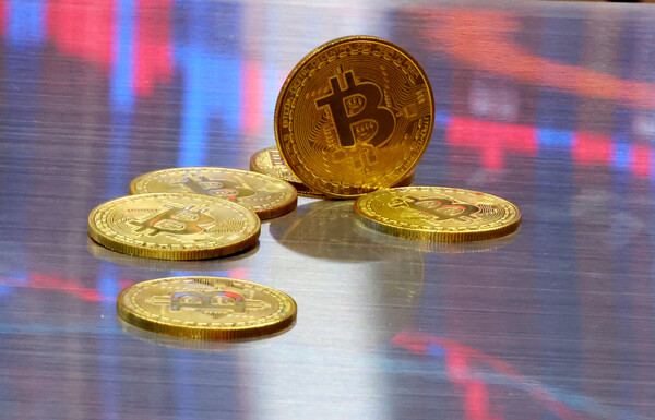 미국 가상화폐 거래소 코인베이스에 따르면 이스라엘과 이란 휴전 합의 소식이 전해진 이후 동부 시간 23일(현지시간) 오후 8시 4분(서부 오후 5시 4분) 비트코인 1개당 가격은 10만5429달러에 거래됐다. 비트코인 모형이 놓인 바닥에 코인 시세 그래프가 비치는 모습. [사진=연합뉴스]